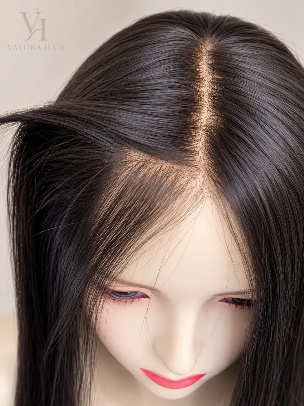 Close-up of the center parting and hairline on a dark wig