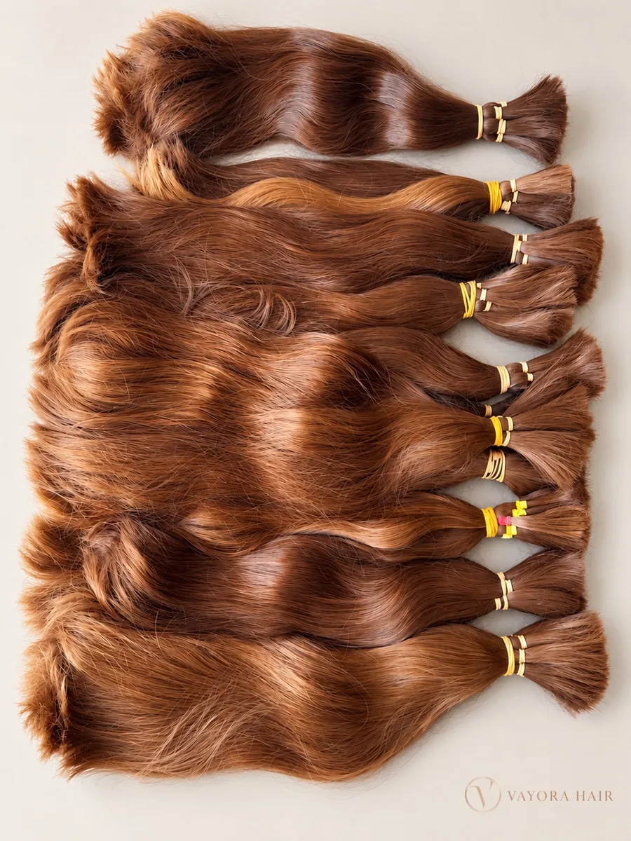 Copper-brown tied hair sample lots laid on a light background
