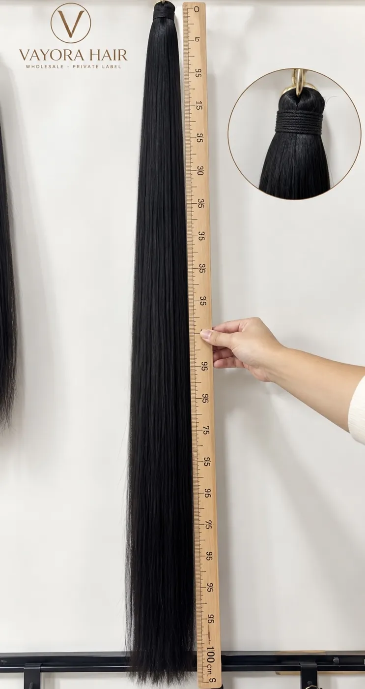 Long dark hair bundle displayed beside a ruler with a root-detail inset