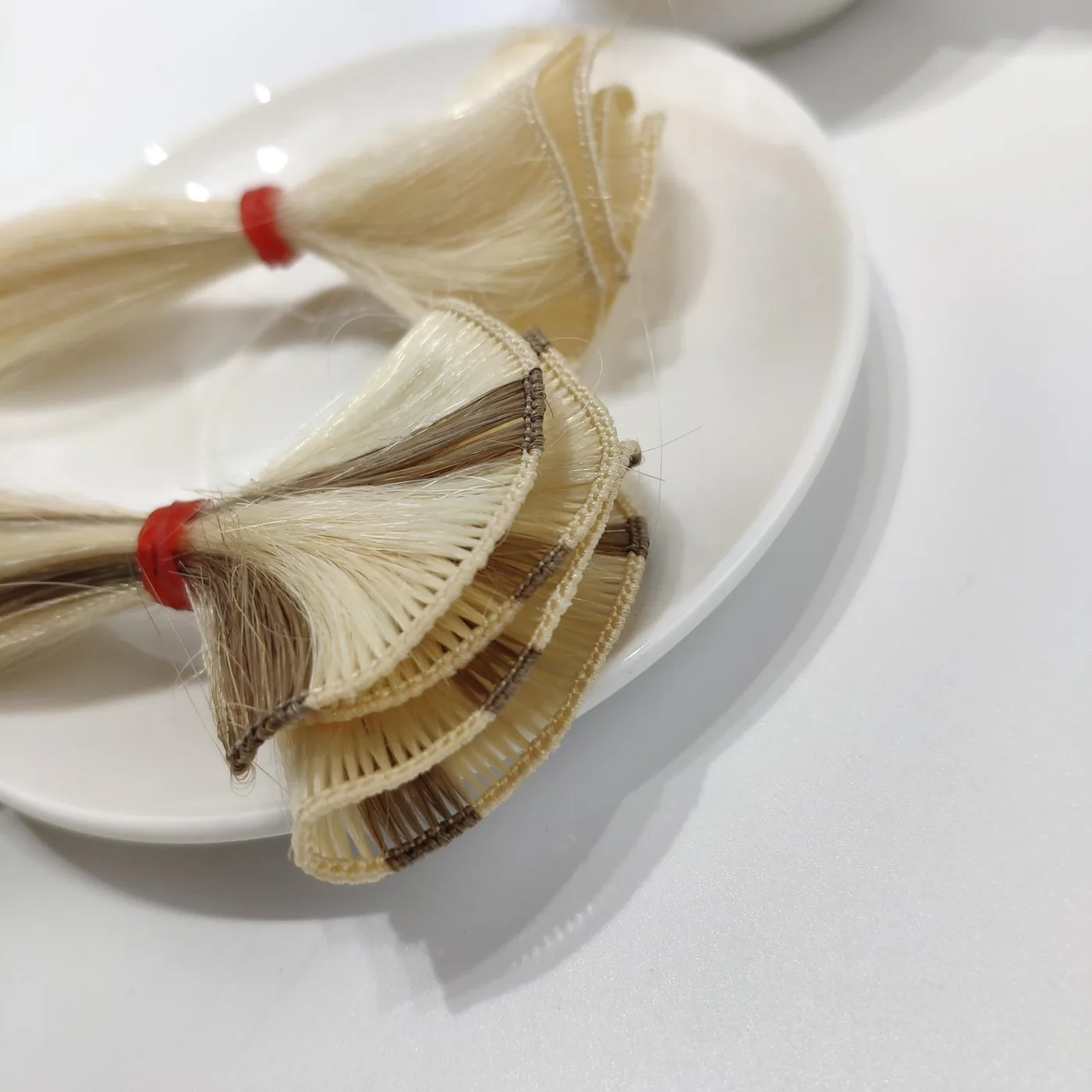 Hand-tied human hair weft sections