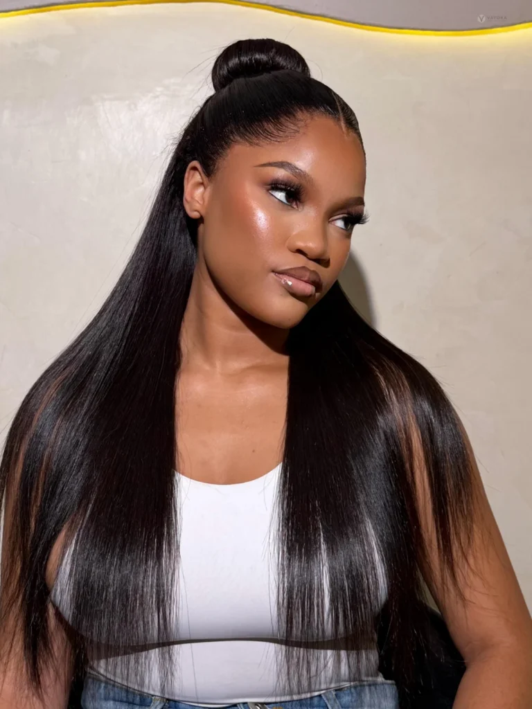 Model with long sleek dark hair styled partly up