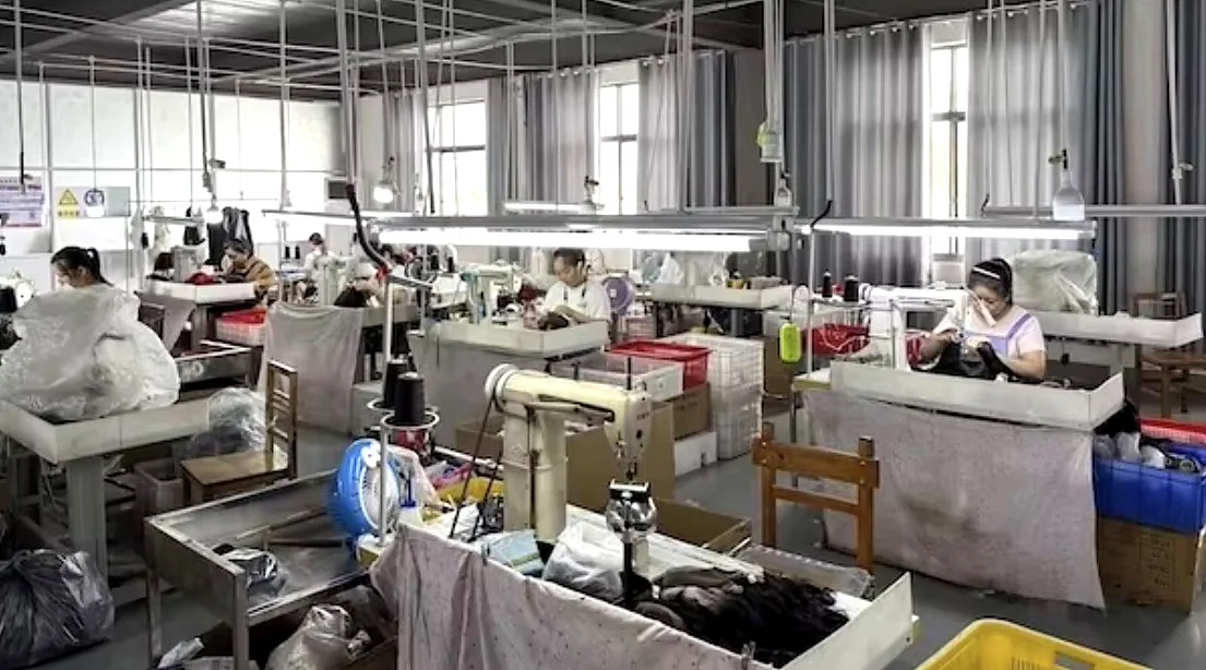 Workers using sewing machines in VAYORA’s Xuchang manufacturing partner wig workshop.